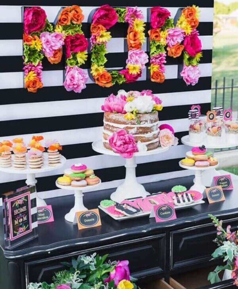 22- Na decoração dia das mães colorida, as flores ganham destaque no painel sobre os doces e bolos. Fonte: Flores Como Fazer em Casa