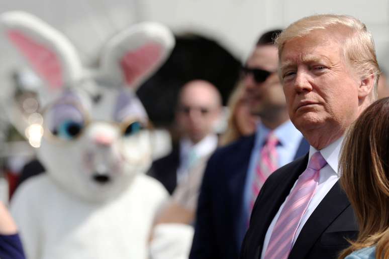 Pessoa vestida com traje de coelho olha pra o presidente dos Estados Unidos, Donald Trump, durante comemoração da Páscoa na Casa Branca.  l 22/4/2019.   REUTERS/Jonathan Ernst 
