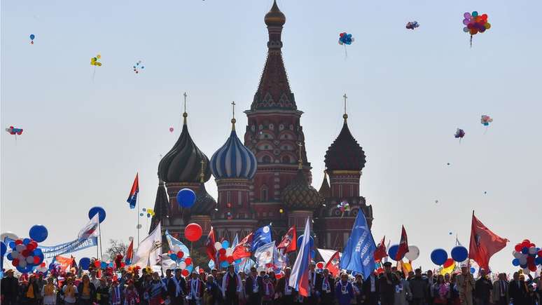 As pessoas celebram 1º de maio com bandeiras, balões, música e dança na Praça Vermelha, em Moscou