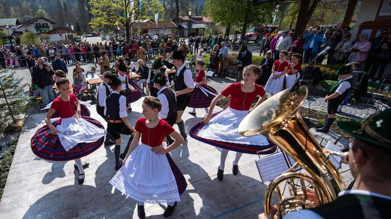 Members of the 'D"Leonhardstoana' costume group wear traditional dresses as they dance during the maypole festival in southern Germany