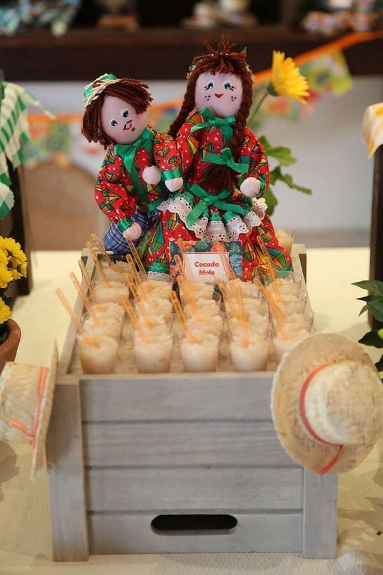 35- Decoração de festa junina tem copinhos de cocada com bonequinhos para enfeitar a mesa principal. Fonte: Pinterest