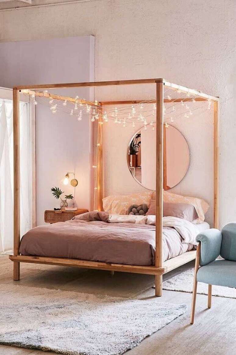 34. Decora&ccedil;&atilde;o rom&acirc;ntica para quarto com espelho redondo e cama com dossel e varal de luzinhas &ndash; Foto: Amanda Doublin