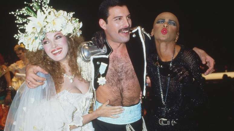 Jane Seymour em um vestido de Emanuel, com Freddie Mercury e amigo em um evento beneficente da Fashion Aid em 1985