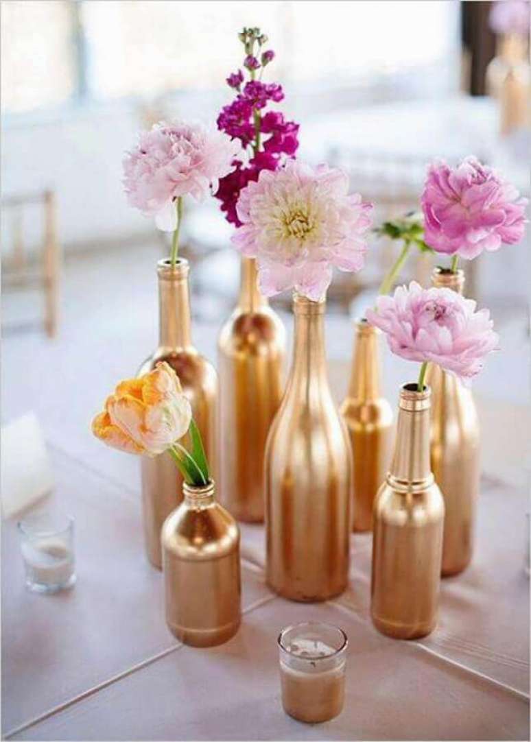 57. Ideia de enfeite de mesa para casamento simples com garrafas pintadas de dourado – Foto: Casa e Festa