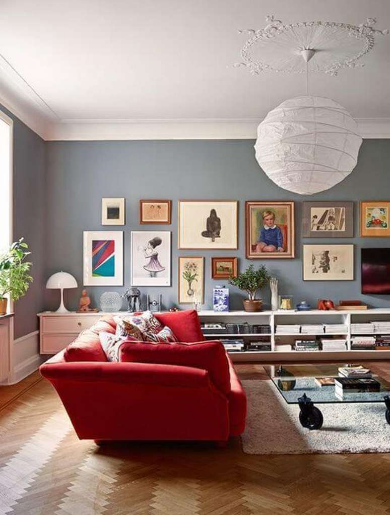 4. Decoração de sala com sofá vermelho e composição de quadros na parede – Por: Pecans Thome Deor
