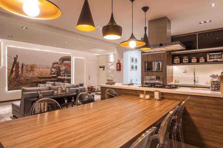 70. A mesa de jantar de madeira pode ter cadeiras transparentes para contrastar. Projeto de Raduan Arquitetura