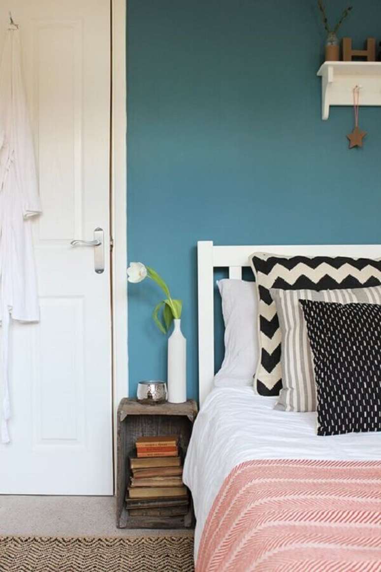 47. Quarto simples decorado com tinta de parede azul petróleo e cabeceira branca – Foto: Pinterest