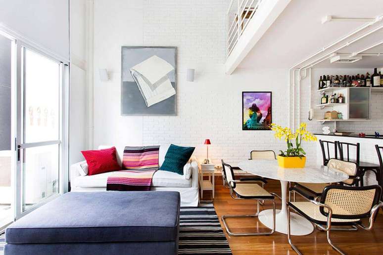 28. Neste ambiente claro, o tapete em cores escuras se destaca. Projeto de Pereira Reade