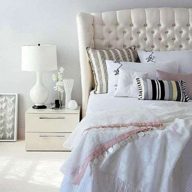 80. Quarto todo decorado na cor branca com cabeceira capitonê e modelos de criado mudo pequeno – Foto: Pinterest