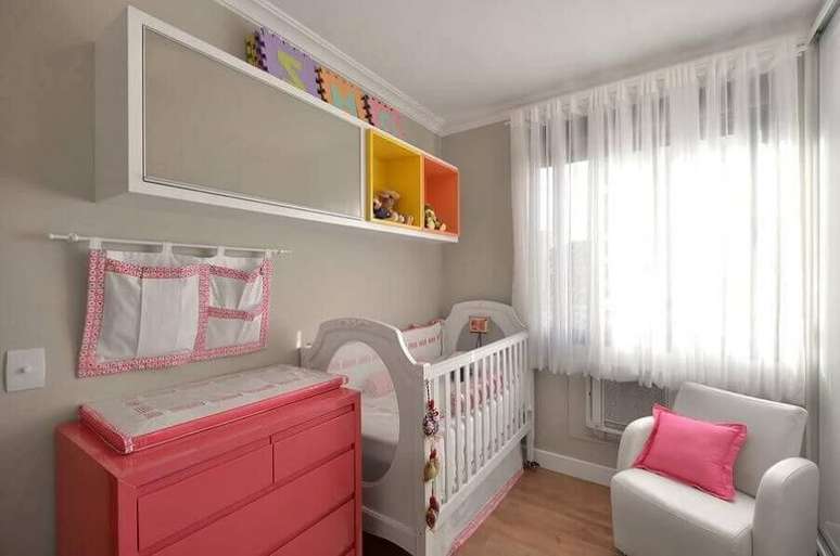 30. Cômoda rosa para quarto de bebê todo branco com nichos coloridos – Foto: Alessandra Bonotto
