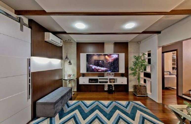 54. Sala ampla decorada com rack com painel branco – Foto: Espaço do Traço Arquitetura