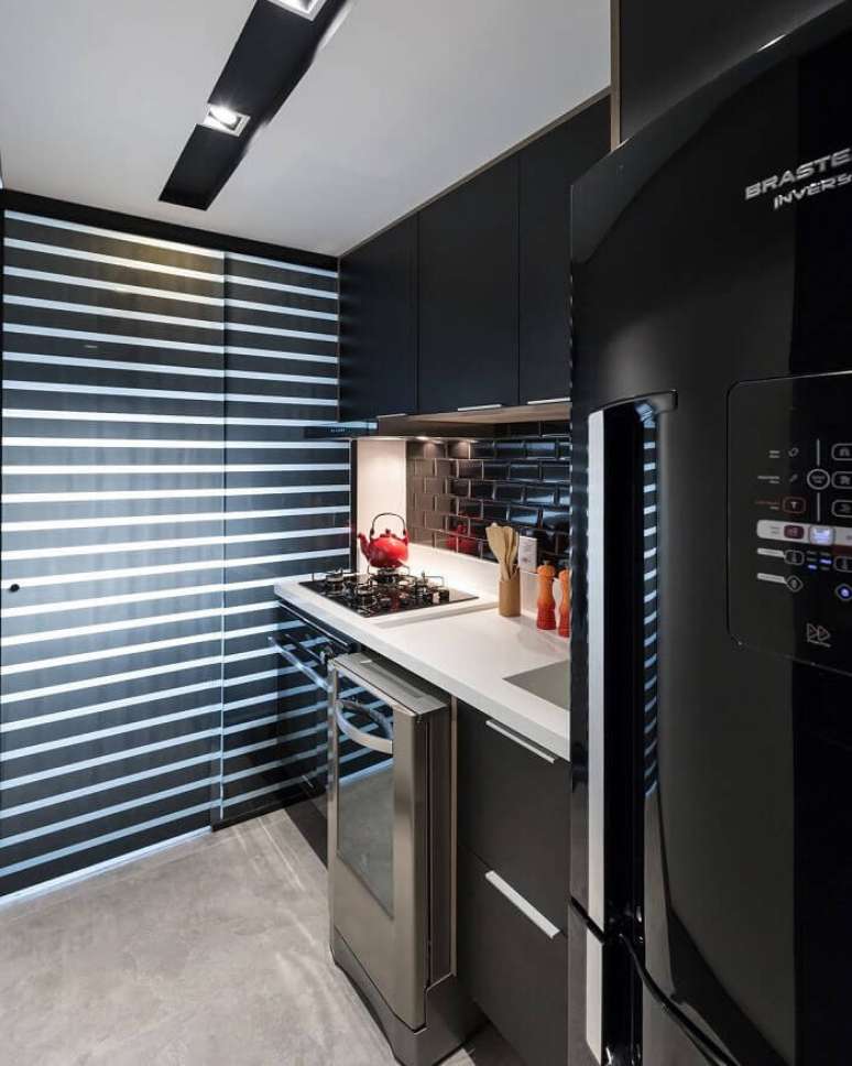 36. Cozinha compacta com geladeira preta embutida. Fonte: Braccini e Lima Arquitetura