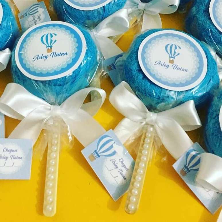 53. Lembrancinha f&aacute;cil de fazer. Pirulito feito com pequena toalha de rosto dobrada. Fonte: Papel M&aacute;gico