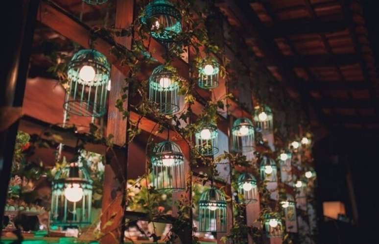53. Parede formada em madeira e gaiolas decorativas separam os ambientes da festa. Fonte: Pinterest