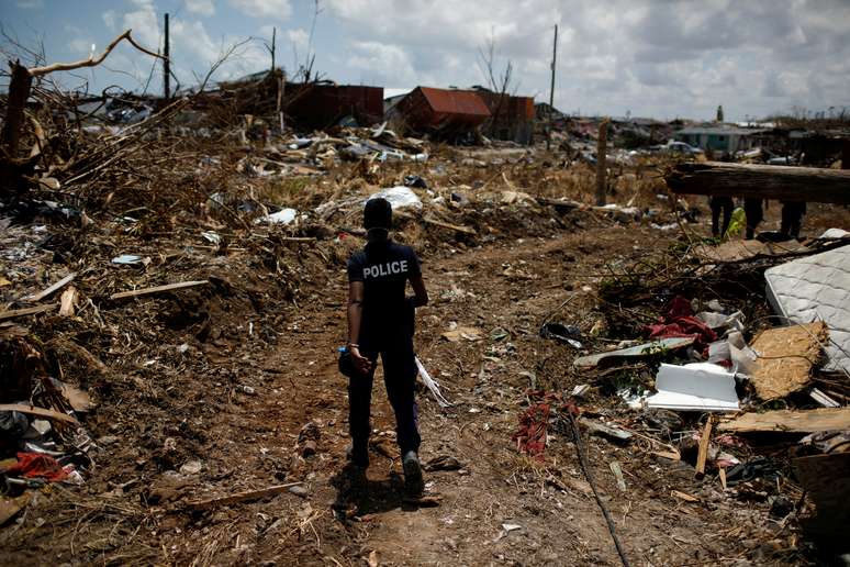 Oficial da polícia procura por vítimas após a passagem do furacão Dorian, nas Bahamas. 10/9/2019. REUTERS/Marco Bello