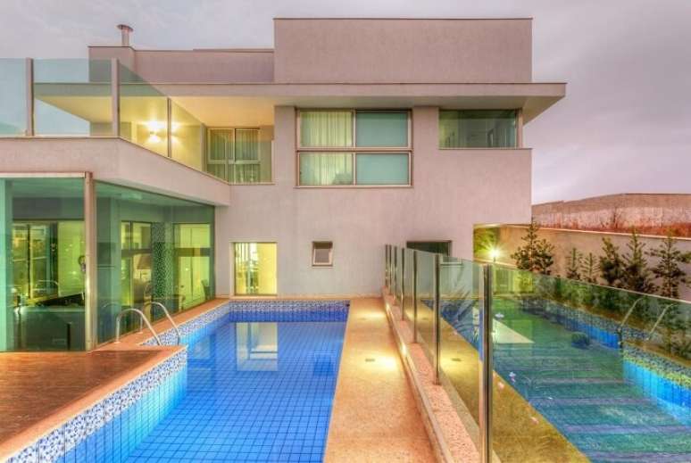 61. Fachada de vidro &eacute; muito utilizada em projetos de casas com piscina. Projeto por JANAINA NAVES Design & Arquitetura