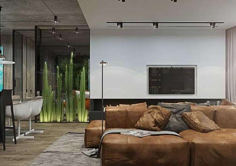 69. Decoração industrial sala de estar com sofá de couro marrom – Foto: Apartment Therapy