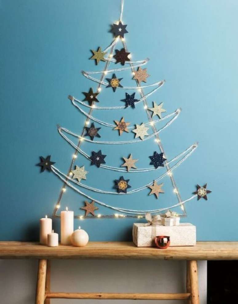 31. Árvore de Natal na parede feita com estrelas e pisca pisca. Fonte: Pinterest