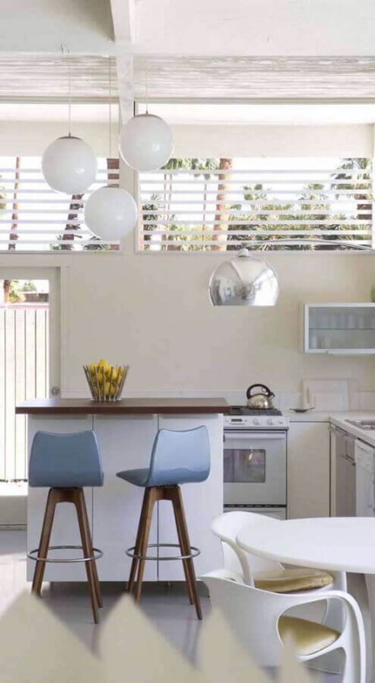 21. Decora&ccedil;&atilde;o clean com cadeira girat&oacute;ria para cozinha toda branca com pequena ilha &ndash; Foto: Casas Pr&eacute; Fabricadas