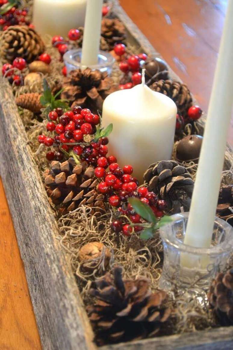 48. Arranjos de natal com velas e pinhas em suporte rústico de madeira – Foto: Leka Guimarães