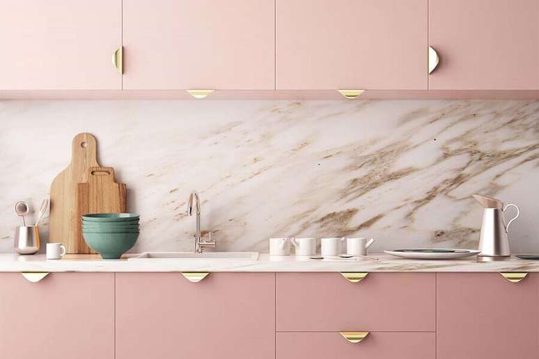 4. Decoração moderna para cozinha rosa com puxadores dourados no armário e revestimento sofisticado – Foto: AuthGram