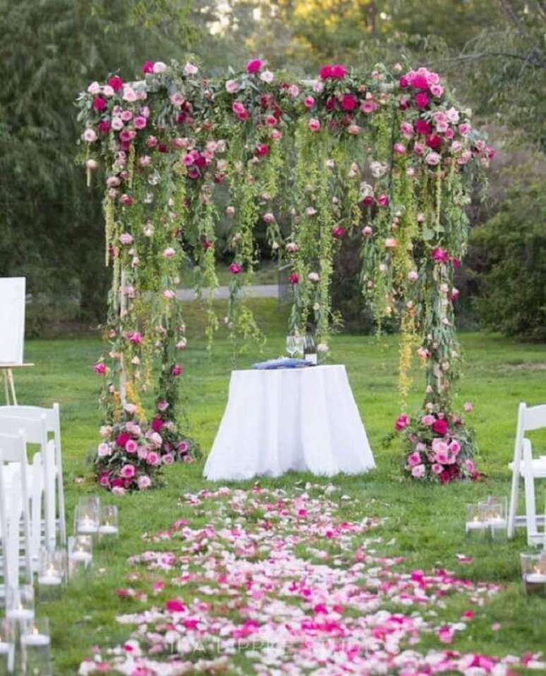 3. Decora&ccedil;&atilde;o rom&acirc;ntica para casamento no campo de dia com flores e folhas decorando o altar &ndash; Foto: MODwedding