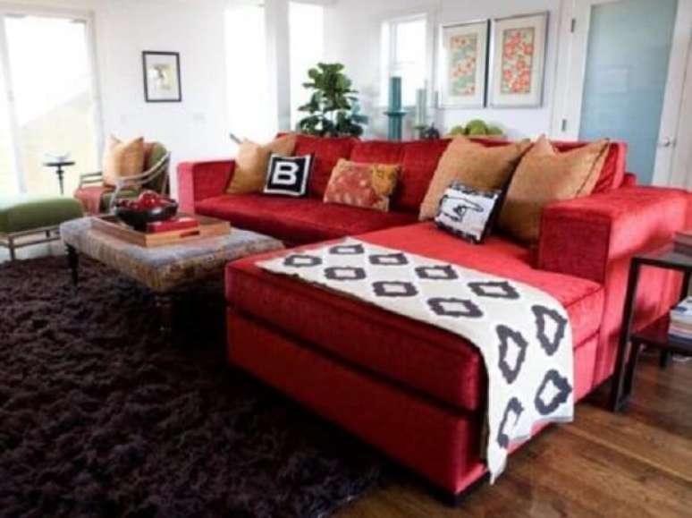 56. Sala de estar com sofá suede vermelho e tapete felpudo. Fonte: Pinterest