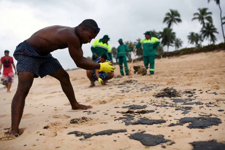 Moradores ajudam a limpar óleo da praias de Barra de Jacuipe, na Bahia