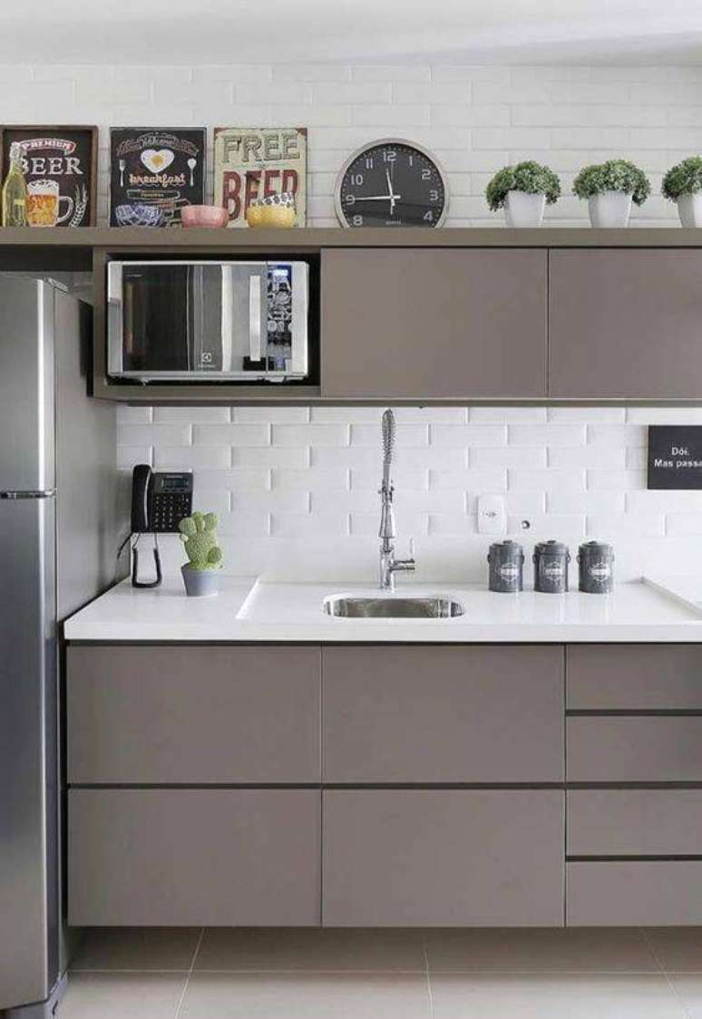 42. A cozinha cinza com tijolinhos brancos é muito clássica e moderna ao mesmo tempo. Foto: Revestindo a Casa