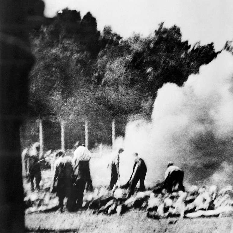 Fotografia sem data tirada secretamente pela Organização de Resistência clandestina no campo de Auschwitz-Birkenau, mostrando como os prisioneiros foram forçados a incinerar os cadáveres do lado de fora quando os crematórios estavam lotados