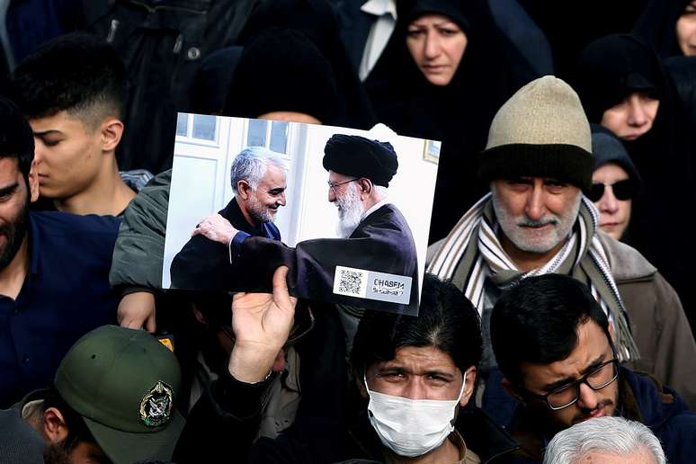 Manifestante segura cartaz com foto de l&iacute;der aiatol&aacute; Ali Khamenei com Soleimani, durante protesto em Teer&atilde; por morte de comandante 3/3/2020 WANA (West Asia News Agency)/Nazanin Tabatabaee via REUTERS