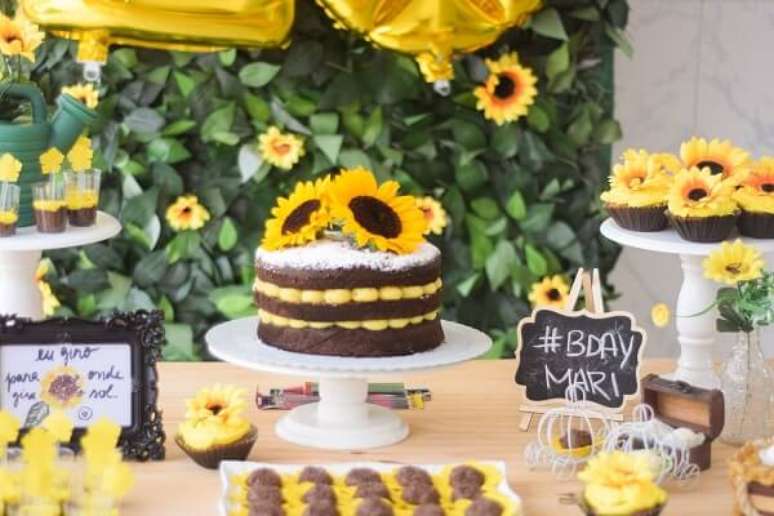 19. As flores foram espalhadas por toda a mesa do bolo da festa tema girassol. Fonte: Pinterest