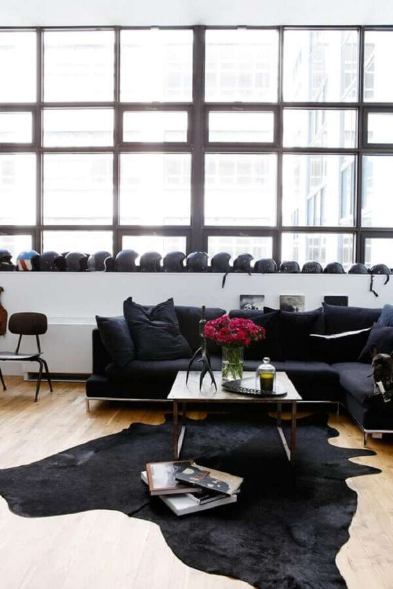 33. Sala decorada com sofá e tapete de couro preto – Foto: Remodelista