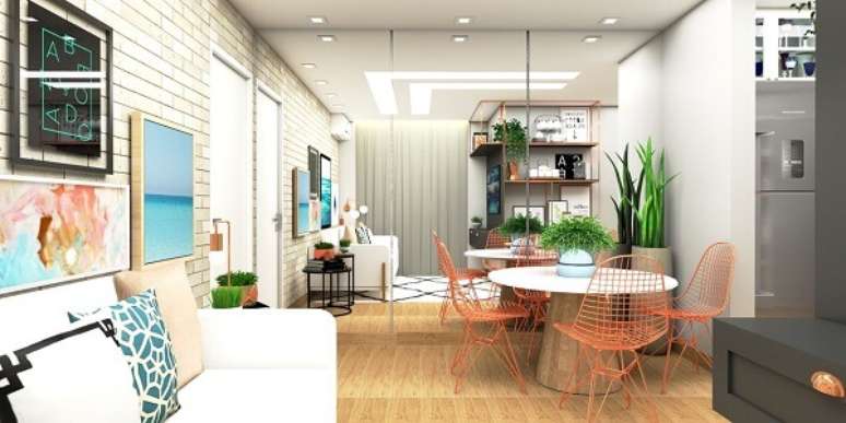 61. Mesa de jantar redonda com cadeiras met&aacute;licas. Projeto por G+G Interiores