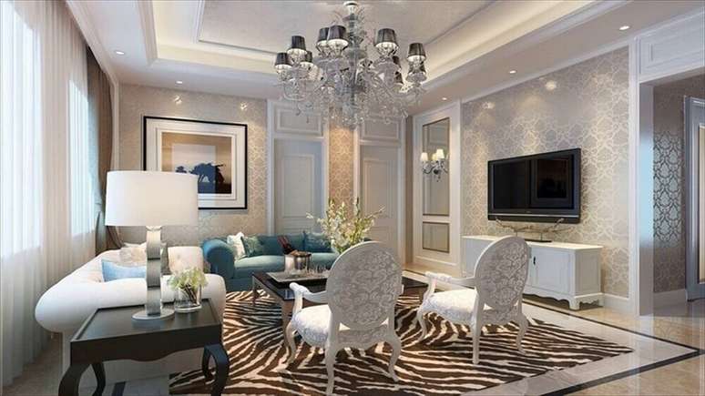 30. Sala decorada com lumin&aacute;rias de teto tipo lustre