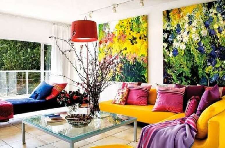 2. O sofá amarelo se harmoniza com os quadros decorativos do ambiente. Fonte: Pinterest