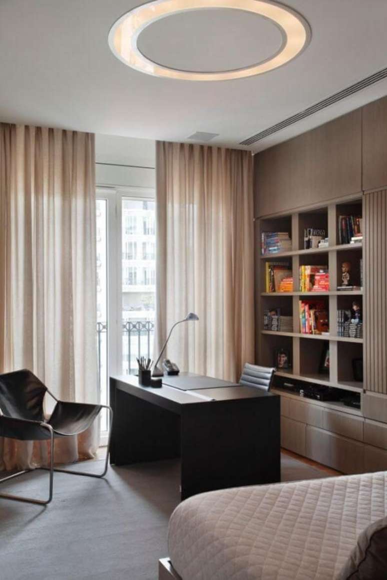 16. Escrit&oacute;rio planejado com cadeira paulistano preta e nichos. Projeto por A1 Arquitetura