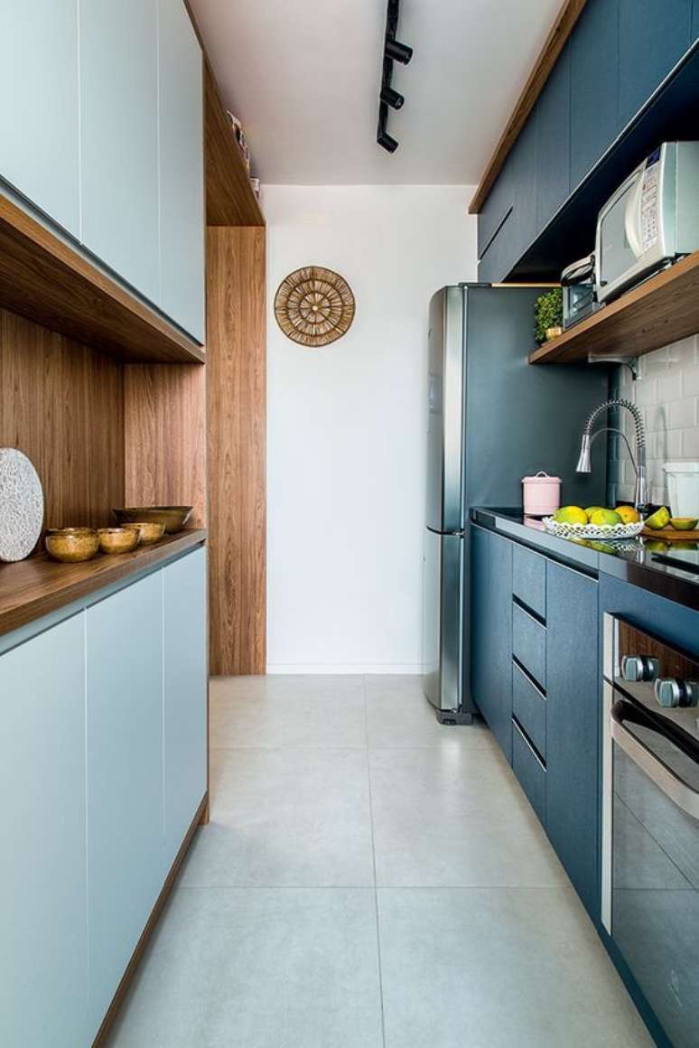 10. Decoração de armário de cozinha para ambiente com marcenaria azul e iluminação moderna – Via: Revista VD