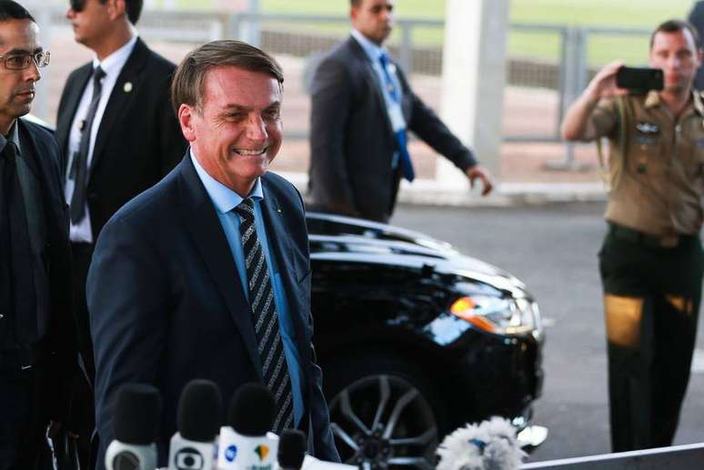 Jair Bolsonaro cumprimenta apoiadores na frente do Palácio da Alvorada.