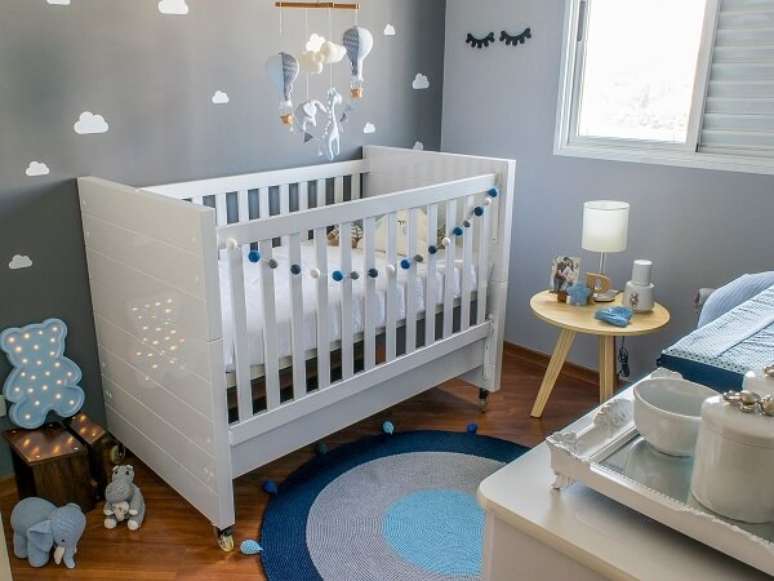 34. Optar por um quarto de bebê cinza e azul com itens de decoração variados é uma forma de trazer um ar criativo ao ambiente – Foto: Noma Estúdio