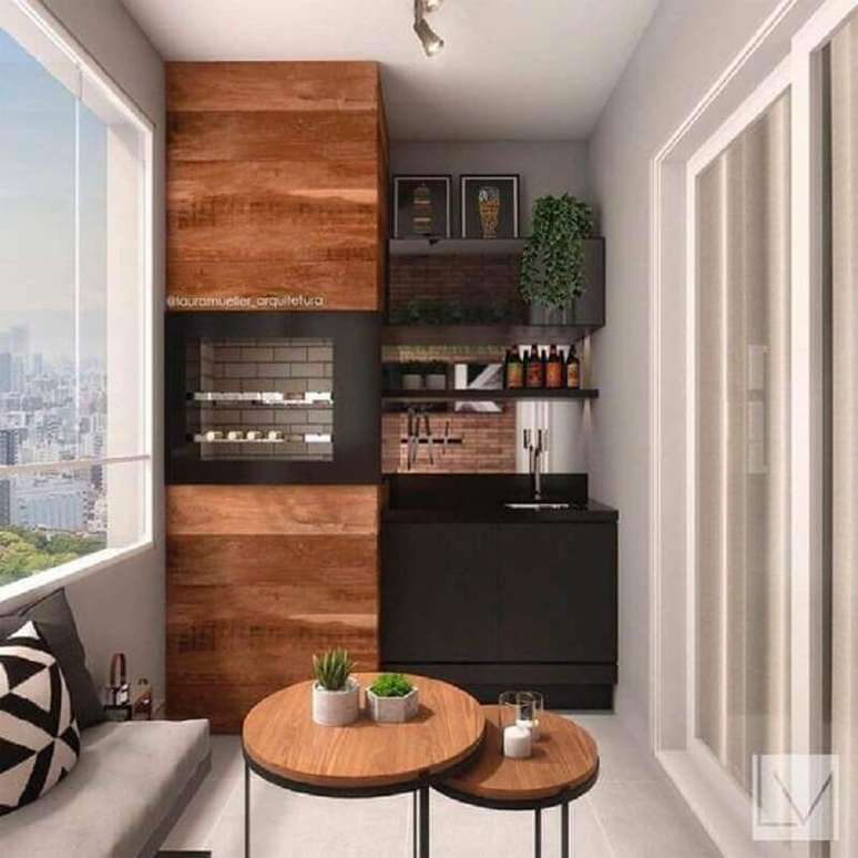 14. Decoração de apartamento com área gourmet planejada com churrasqueira e armário preto – Foto: Deco Design
