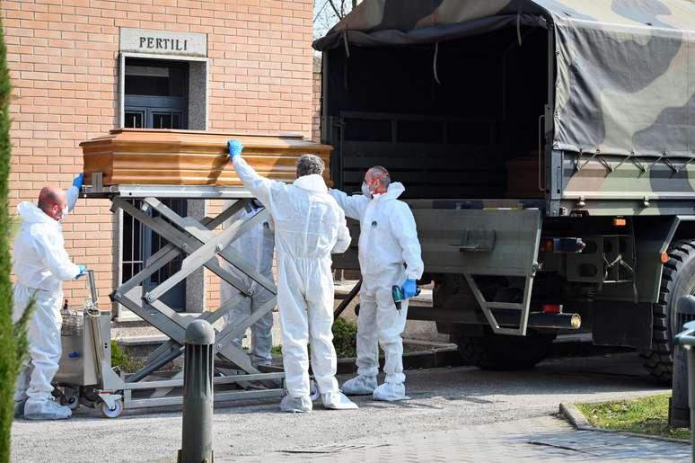 Um comboio de caminhões do Exército italiano carregando corpos de vítimas de coronavírus que vinham de Bergamo é descarregado no Cemitério de Ferrara, na Itália.