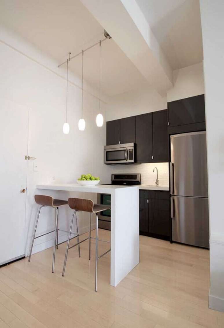 37. Decoração clean para cozinha americana com armários pretos e bancada branca simples – Foto: Houzz