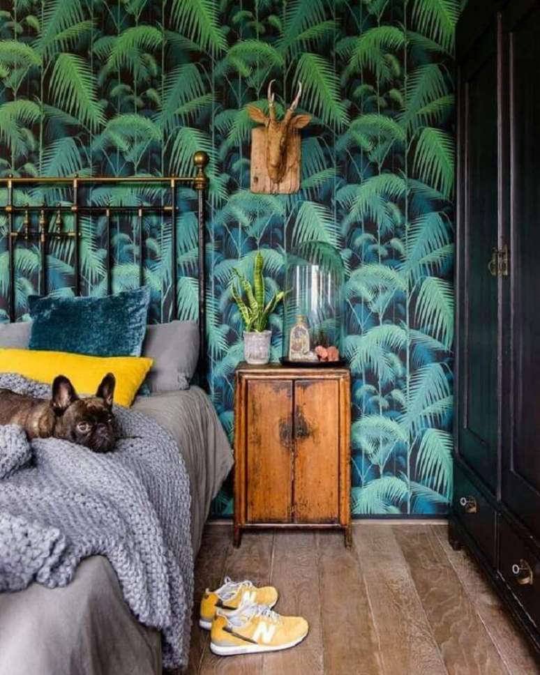 78. Papel de parede para quarto com estampa de folhagens e criado mudo antigo de madeira &ndash; Foto: Telas & Papel