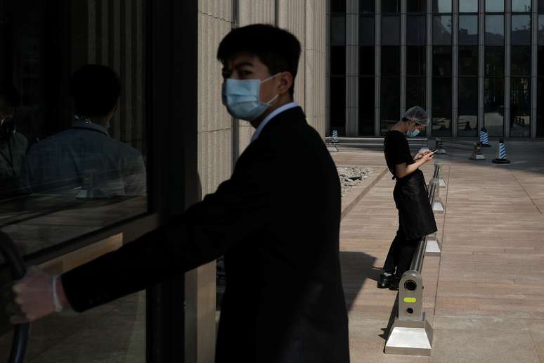 Chineses com máscara de proteção caminham pelo distrito financeiro de Pequim
17/04/2020
REUTERS/Thomas Peter