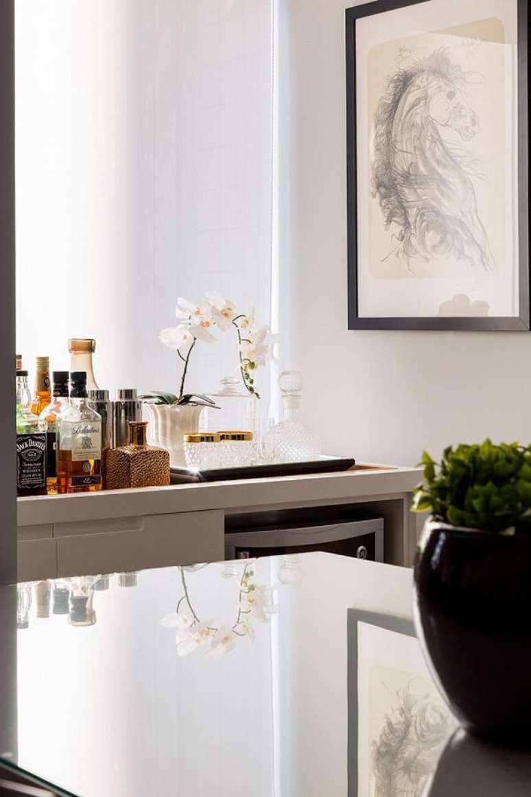 52. As garrafas do home bar kit foram expostas sobre o aparador. Fonte: Studio Novak