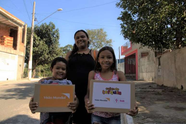 No Capão Redondo, em São Paulo, Rauderlane Batista de Oliveira, de 31 anos, grávida de cinco meses, e os filhos Maysa e Samuel, que receberam kits durante pandemia do novo coronavírus.