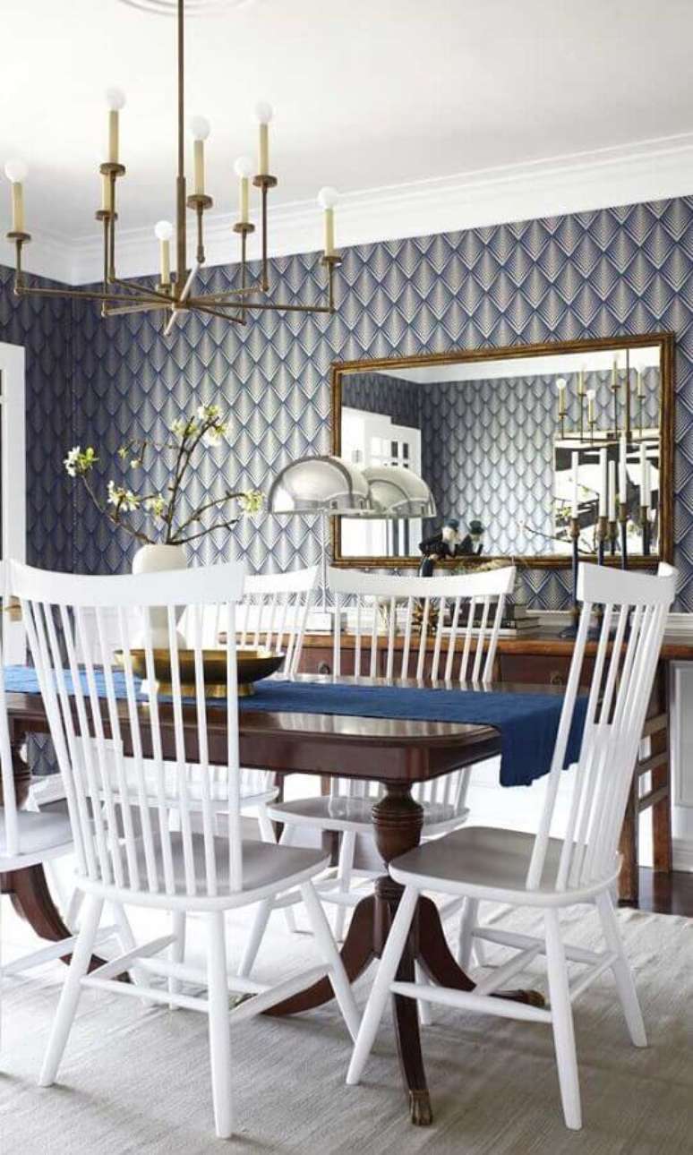 69. Espelho para sala de jantar sofisticada decorada com papel de parede azul e lustre moderno – Foto: Casinha Colorida