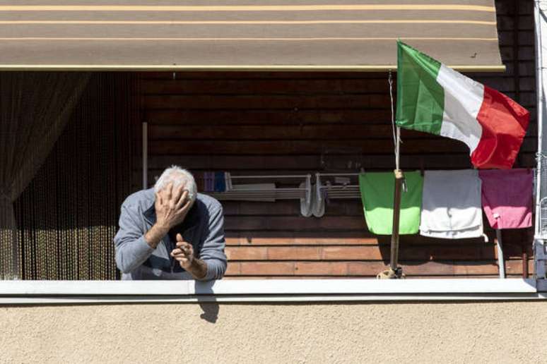 Italiano na sacada de seu apartamento em Roma, capital do país, durante quarentena por coronavírus