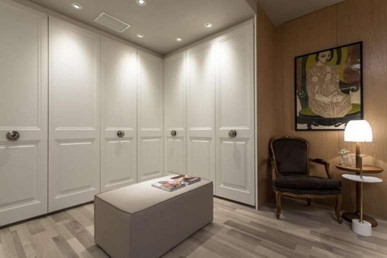 47. Guarda roupa em L casal branco e cadeira de veludo. Projeto por Manarelli Guimar&atilde;es Arquitetos